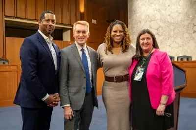 FOTH Host Partners Smiling and Posing with Sen. Lankford (R-OK) in a Senate Hearing Room