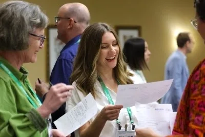 Forum members smiling and talking at ForumCon24